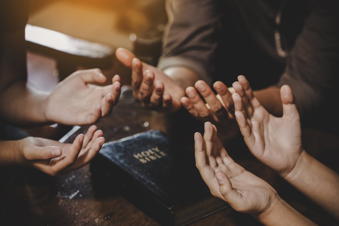 Group of different women praying together